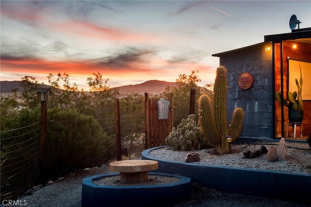 view of yard featuring fence and a mountain view