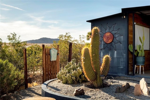 exterior space featuring fence and a mountain view