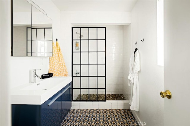 bathroom with a walk in shower and vanity