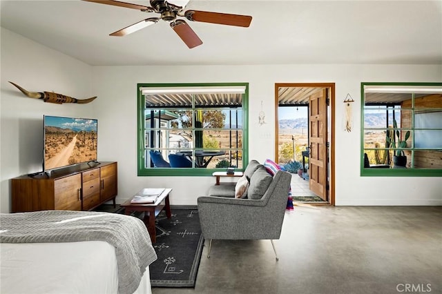 bedroom featuring finished concrete floors and ceiling fan