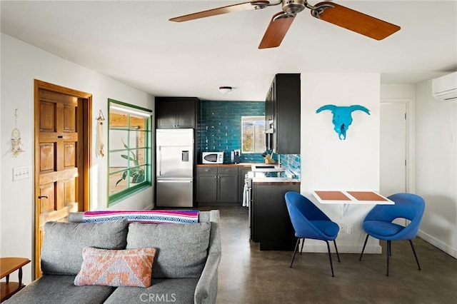 living room featuring concrete flooring, a wall unit AC, and baseboards