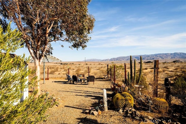 view of yard with a mountain view and a rural view