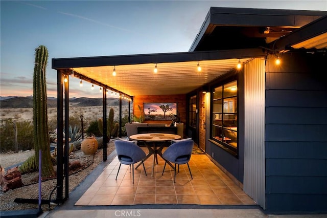 view of patio with outdoor dining area and a mountain view