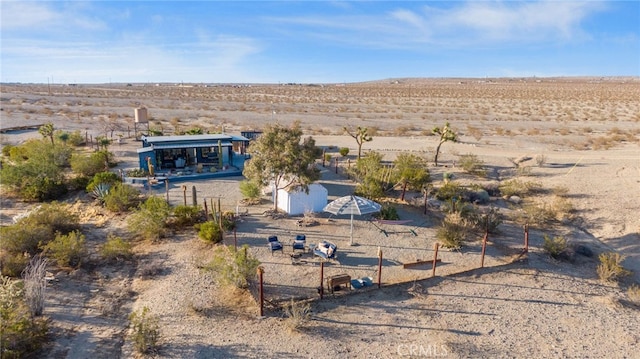 birds eye view of property featuring view of desert and a rural view