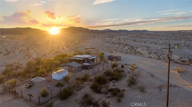 exterior space featuring a desert view and a mountain view