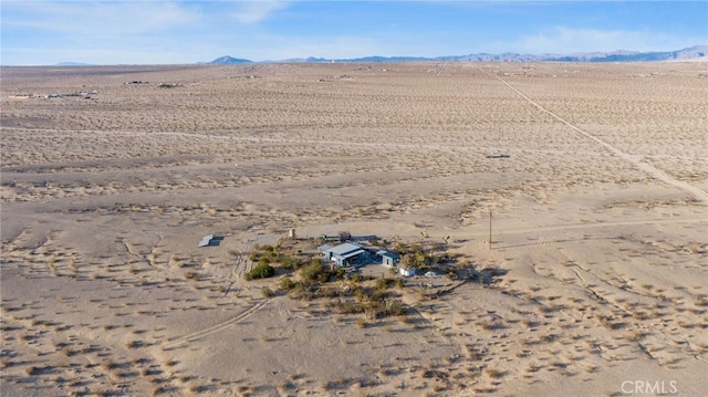 birds eye view of property with view of desert, a rural view, and a mountain view