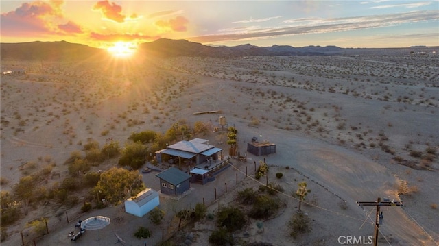 birds eye view of property featuring a desert view and a mountain view