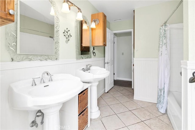 42397 Santiago Dr, Hemet, CA 92544 - full bathroom with wainscoting, tile patterned floors, shower / tub combo with curtain, and a sink