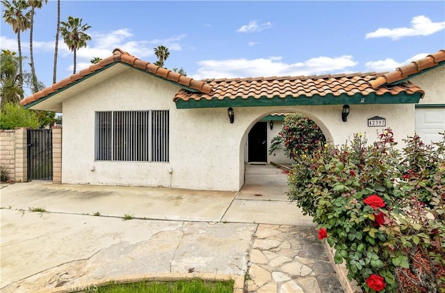 42397 Santiago Dr, Hemet, CA 92544 - back of property with a gate, a tile roof, and stucco siding