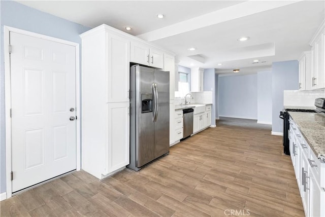 42397 Santiago Dr, Hemet, CA 92544 - kitchen featuring a sink, white cabinets, backsplash, appliances with stainless steel finishes, and light stone countertops