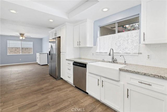 42397 Santiago Dr, Hemet, CA 92544 - kitchen with white cabinets, backsplash, a sink, appliances with stainless steel finishes, and ceiling fan