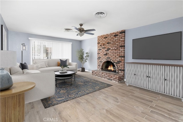 42397 Santiago Dr, Hemet, CA 92544 - living room with ceiling fan, wood finished floors, visible vents, and a fireplace