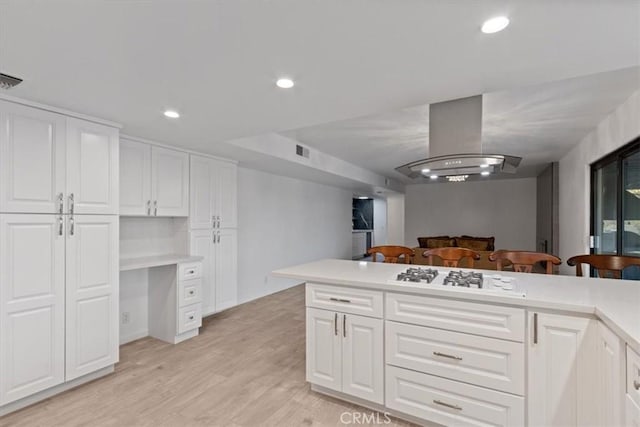 kitchen featuring recessed lighting, white gas cooktop, light wood-style floors, white cabinetry, and extractor fan