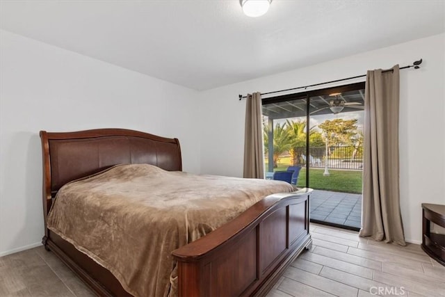 bedroom featuring access to outside, light wood-style flooring, and baseboards