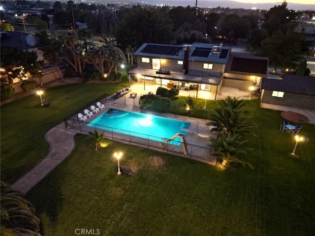 pool at dusk with a patio area, a fenced backyard, a fenced in pool, and a lawn