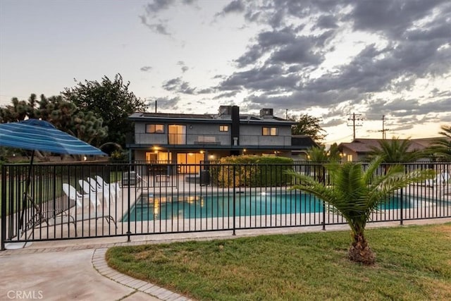 community pool featuring a patio and fence