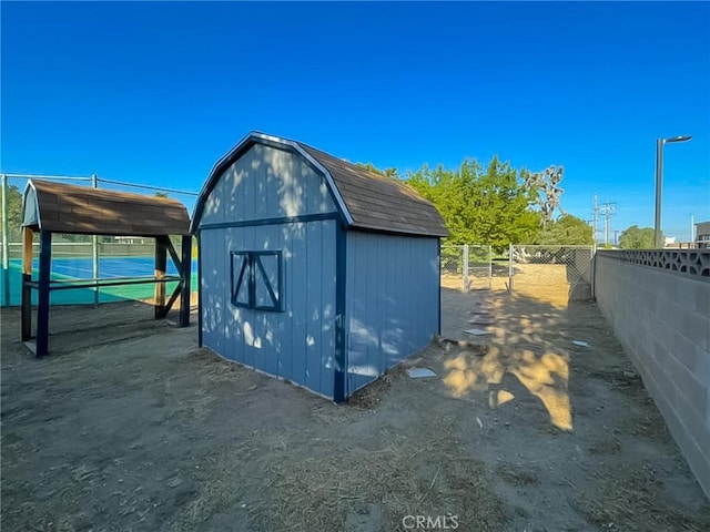 view of shed with fence