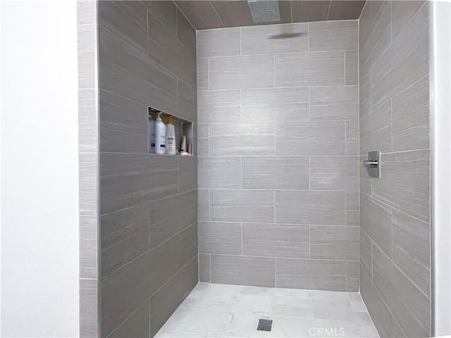 full bath with a tile shower