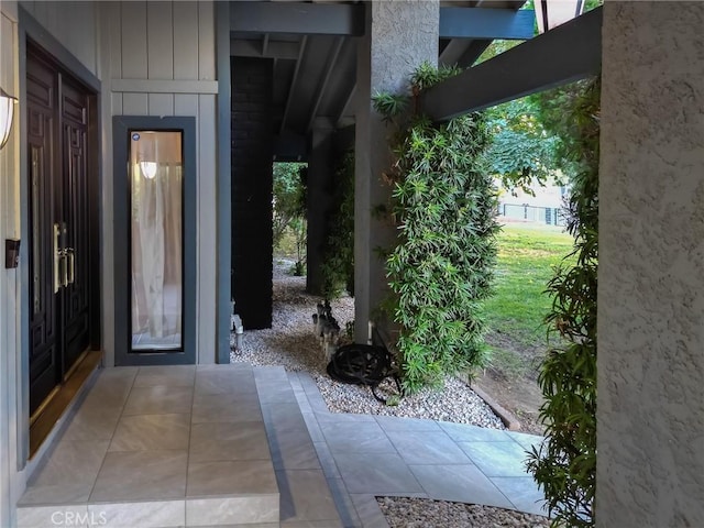 view of exterior entry with board and batten siding