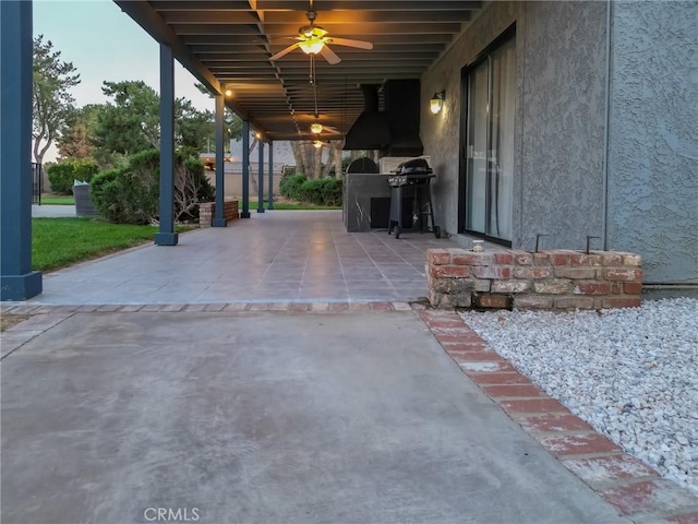 view of patio with ceiling fan and area for grilling