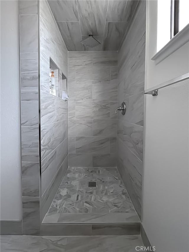 full bathroom featuring tiled shower