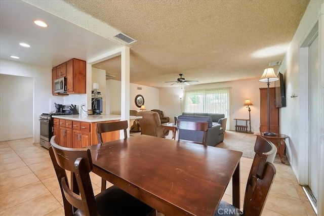 dining room with a ceiling fan, recessed lighting, visible vents, and a textured ceiling