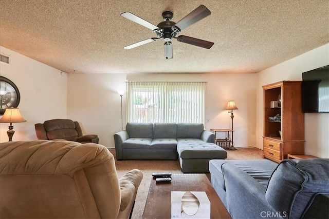 living area with visible vents, light colored carpet, ceiling fan, and a textured ceiling