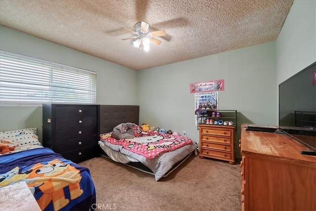 bedroom featuring a textured ceiling, carpet floors, and a ceiling fan