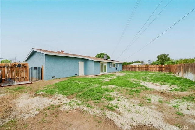 back of house with fence and stucco siding