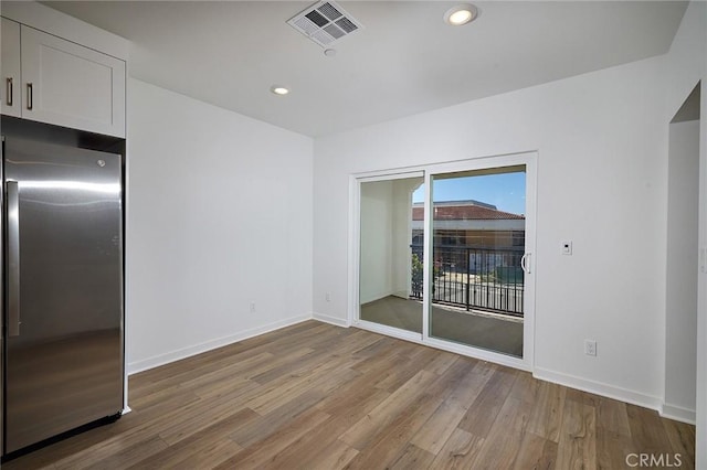 interior space featuring visible vents, recessed lighting, baseboards, and wood finished floors