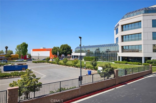 exterior space with uncovered parking and fence