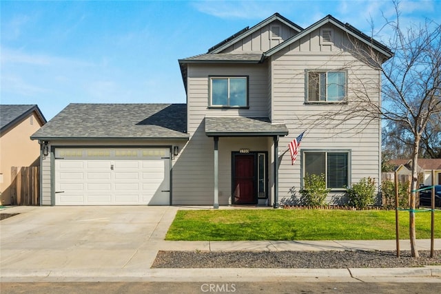 view of front of home featuring concrete driveway, board and batten siding, an attached garage, and a front yard