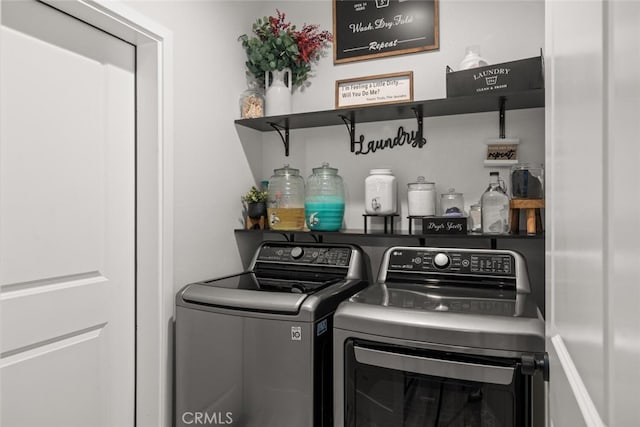 clothes washing area featuring laundry area and washing machine and dryer