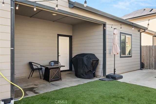 view of patio with a grill and fence