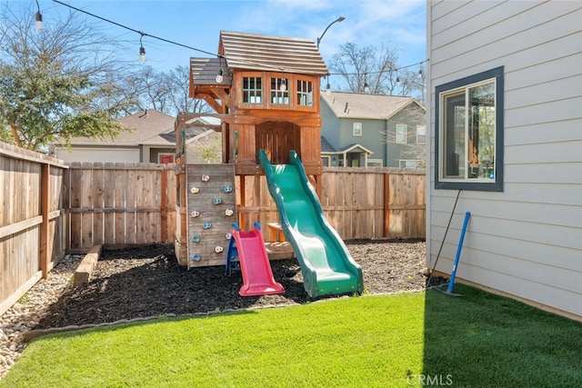 view of playground with a yard and a fenced backyard