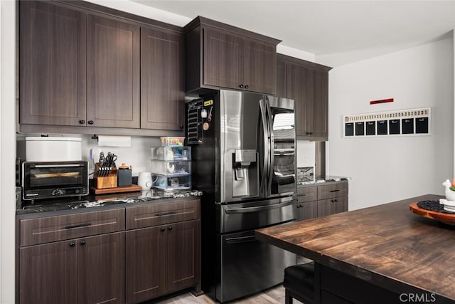 kitchen featuring a toaster, dark brown cabinets, and stainless steel fridge with ice dispenser