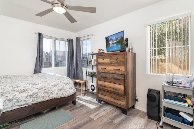 bedroom with a ceiling fan and wood finished floors