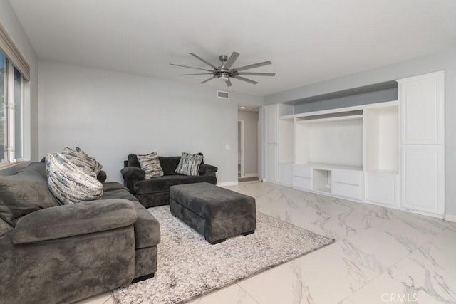 living area featuring marble finish floor, ceiling fan, visible vents, and baseboards