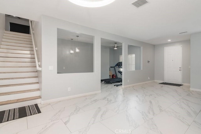 interior space with stairs, marble finish floor, visible vents, and baseboards