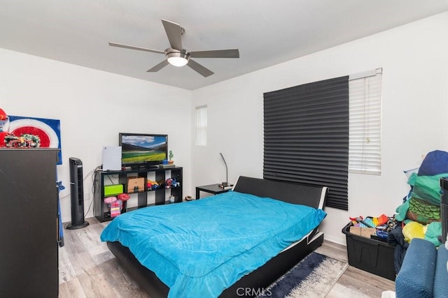 bedroom with a ceiling fan and wood finished floors