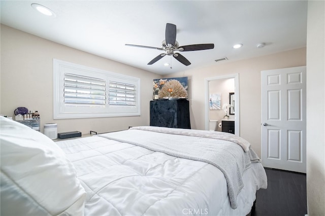 bedroom featuring visible vents, dark wood-type flooring, ensuite bathroom, a ceiling fan, and recessed lighting