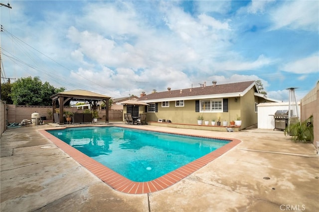 view of pool with a gazebo, a patio area, a fenced backyard, and a grill