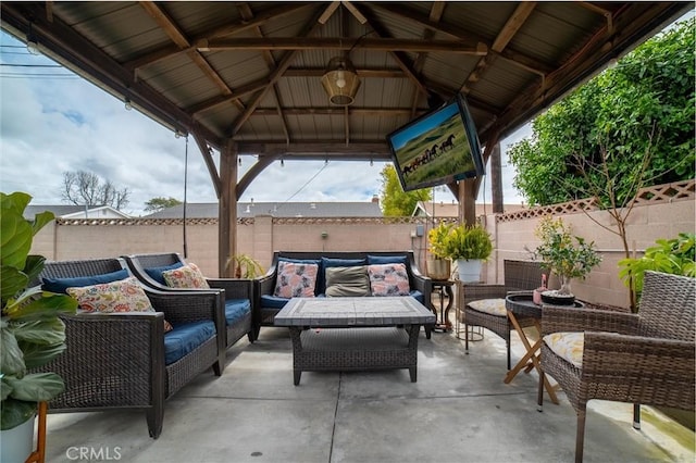 view of patio / terrace with a gazebo, an outdoor living space, and a fenced backyard