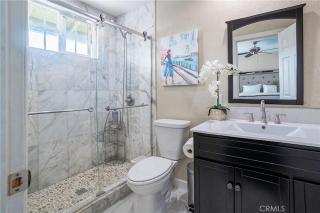 bathroom featuring vanity, toilet, a textured wall, and a marble finish shower