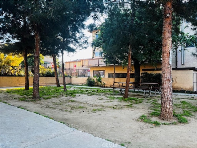 view of home's community with fence