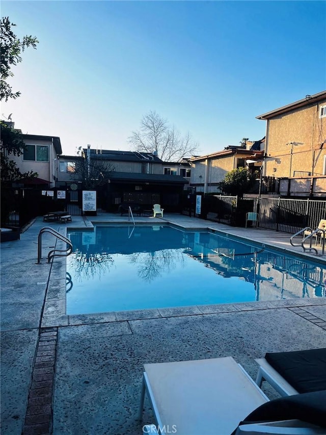 pool featuring a patio area and fence