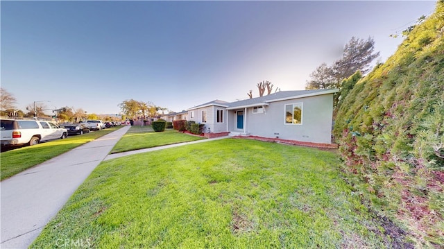 view of front facade featuring stucco siding and a front lawn