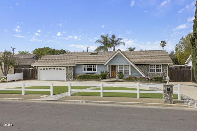 ranch-style home with a fenced front yard, stone siding, and a front lawn