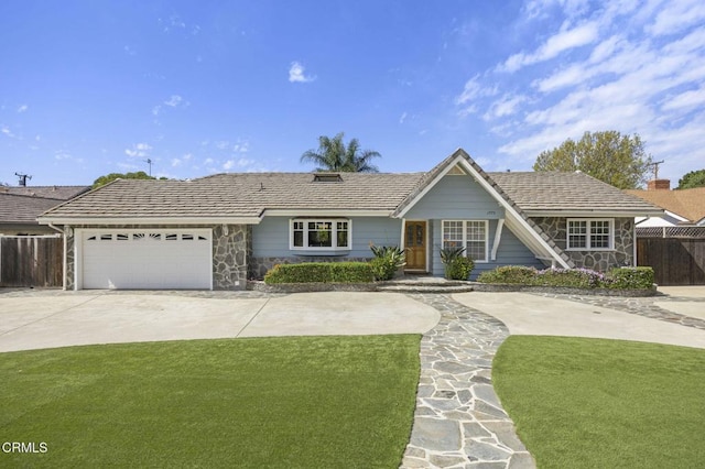 single story home featuring a garage, stone siding, concrete driveway, and fence