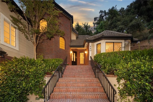 property entrance featuring brick siding